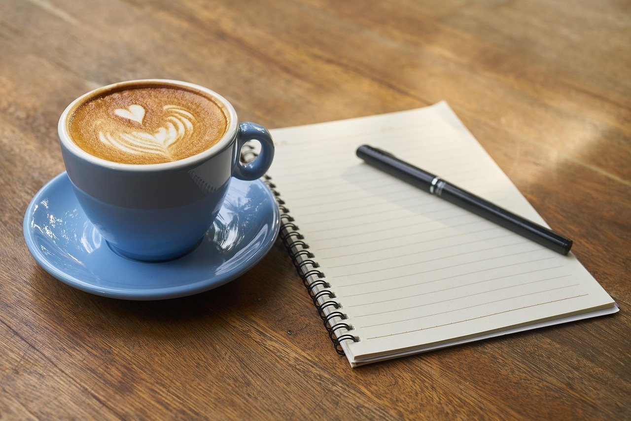 Coffee cup and notebook